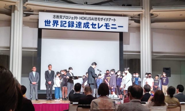 【メディア掲載】京都新聞、Yahoo!ニュースに亀岡での「HOKUSAI志モザイクアート」世界記録達成セレモニーの様子が掲載